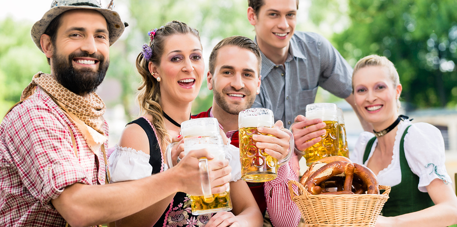 Friends in Bavarian beer garden drinking in summer